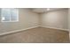 This bedroom features neutral walls, plush carpet, and a bright window for natural light at 6070 Long Branch Dr, Parker, CO 80134