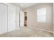 A carpeted bedroom featuring a closet with sliding doors and a view into the hall at 6070 Long Branch Dr, Parker, CO 80134
