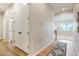 Well-lit hallway with wood floors and a view to other rooms in the home at 6070 Long Branch Dr, Parker, CO 80134