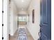 Inviting hallway features wood floors, soft natural light and flows to other rooms in the home at 6070 Long Branch Dr, Parker, CO 80134