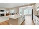 Modern kitchen with stainless steel appliances, white cabinets, a central island, and hardwood floors at 6070 Long Branch Dr, Parker, CO 80134