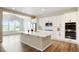 A modern kitchen with stainless steel appliances, white cabinets and countertop, and wood flooring at 6070 Long Branch Dr, Parker, CO 80134