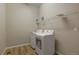 Clean laundry room equipped with a washer, dryer, and a wire shelf at 6070 Long Branch Dr, Parker, CO 80134