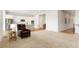 Open living room with wood floors, neutral carpet, and views of the kitchen and a staircase at 6070 Long Branch Dr, Parker, CO 80134