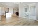 Spacious room with hardwood floors and views of the patio, kitchen, living room, and stairway at 6070 Long Branch Dr, Parker, CO 80134