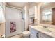 Cozy bathroom featuring a shower with glass doors, a vanity, and classic fixtures at 3240 E 128Th Pl, Thornton, CO 80241
