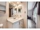 Well-lit bathroom with a vanity and a view to the adjacent bedroom at 3240 E 128Th Pl, Thornton, CO 80241