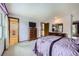 Spacious bedroom featuring carpet, decorative curtains, furniture, and a view of the en suite bathroom at 3240 E 128Th Pl, Thornton, CO 80241