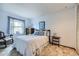 Comfortable bedroom featuring a rocking chair and natural light at 3240 E 128Th Pl, Thornton, CO 80241