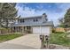 Charming two-story home with a well-maintained lawn, a two car garage, and a double mailbox at 3240 E 128Th Pl, Thornton, CO 80241
