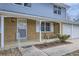Inviting covered front porch with seating, brick facade, and well manicured landscaping at 3240 E 128Th Pl, Thornton, CO 80241