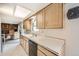 An open kitchen with wood cabinets, white countertops, and stainless steel appliances at 3240 E 128Th Pl, Thornton, CO 80241