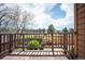 View from the weathered balcony overlooking the fenced yard and neighborhood buildings at 7900 E Dartmouth Ave # 75, Denver, CO 80231