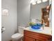 A stylish powder room with a blue glass bowl sink on a wood cabinet and a modern faucet at 7900 E Dartmouth Ave # 75, Denver, CO 80231