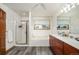 Bright bathroom featuring a bathtub with tiled backsplash, a shower, and a double vanity with wood cabinets at 7900 E Dartmouth Ave # 75, Denver, CO 80231