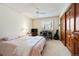Bedroom with a large window, a desk, a ceiling fan, and light pink bedding at 7900 E Dartmouth Ave # 75, Denver, CO 80231