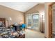 Bright bedroom with a floral bedspread, a desk, a vaulted ceiling, and doors leading to a balcony at 7900 E Dartmouth Ave # 75, Denver, CO 80231