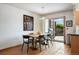 Cozy dining area with modern chairs, a wooden table, and access to the outdoor deck at 7900 E Dartmouth Ave # 75, Denver, CO 80231