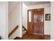 Welcoming entryway with a solid wood door, sidelight, and adjacent staircase leading upstairs at 7900 E Dartmouth Ave # 75, Denver, CO 80231