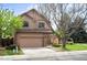 Charming two-story house with a brick facade, attached garage and well-manicured lawn with mature trees at 7900 E Dartmouth Ave # 75, Denver, CO 80231