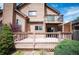 Two-story home featuring wooden deck and backyard at 7900 E Dartmouth Ave # 75, Denver, CO 80231