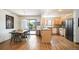 Open kitchen and dining area with stainless steel appliances, wood cabinets, and a sliding door to the deck at 7900 E Dartmouth Ave # 75, Denver, CO 80231
