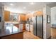Bright kitchen featuring light wood cabinets, granite counters, stainless steel appliances, and hardwood floors at 7900 E Dartmouth Ave # 75, Denver, CO 80231