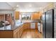 Well-lit kitchen featuring granite countertops, light wood cabinetry, and modern appliances with an adjacent deck at 7900 E Dartmouth Ave # 75, Denver, CO 80231