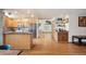 Open-concept layout with a kitchen area, bar, and living room with a large built-in bookshelf at 7900 E Dartmouth Ave # 75, Denver, CO 80231