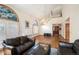 Bright living room featuring hardwood floors, a vaulted ceiling, large windows, and a white piano at 7900 E Dartmouth Ave # 75, Denver, CO 80231