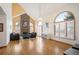 Bright living room with vaulted ceilings, brick fireplace, large arched windows and hardwood floors at 7900 E Dartmouth Ave # 75, Denver, CO 80231