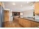 Open concept living space with built-in wooden shelving, hardwood floors, and adjacent to the kitchen area at 7900 E Dartmouth Ave # 75, Denver, CO 80231