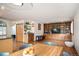 Bright, open floor plan with built-in shelving, hardwood floors, and a dry bar between living and dining areas at 7900 E Dartmouth Ave # 75, Denver, CO 80231