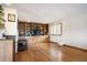 Spacious living room showcasing hardwood floors, a built-in entertainment center, and bright natural light at 7900 E Dartmouth Ave # 75, Denver, CO 80231