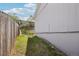 View of the side and back yard featuring lush greenery and a wooden fence at 4670 W Nevada Pl # A, Denver, CO 80219