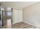 Bedroom with wood floors and double sliding-door closet view to adjacent room at 4670 W Nevada Pl # A, Denver, CO 80219