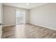Bedroom with light-colored walls, hardwood floors, ceiling fan, and sliding glass doors at 4670 W Nevada Pl # A, Denver, CO 80219