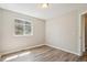 Bright bedroom showcases wood-look floors and natural light from a window at 4670 W Nevada Pl # A, Denver, CO 80219