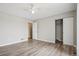 Neutral bedroom with hardwood floors, closet, and doorway to en-suite bath at 4670 W Nevada Pl # A, Denver, CO 80219