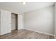 An ample bedroom features neutral paint, a closet and wood-look flooring at 4670 W Nevada Pl # A, Denver, CO 80219