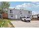 Townhouse featuring a gray exterior and balconies, with parking in front at 4670 W Nevada Pl # A, Denver, CO 80219