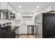 Modern kitchen with stainless steel appliances, subway tile backsplash, and white cabinets at 4670 W Nevada Pl # A, Denver, CO 80219
