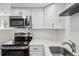 Kitchen featuring stainless steel appliances, white countertops, and subway tile backsplash at 4670 W Nevada Pl # A, Denver, CO 80219