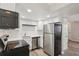 Bright kitchen features stainless steel appliances, white cabinets, and subway tile backsplash at 4670 W Nevada Pl # A, Denver, CO 80219