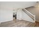 Open-concept living area with wood floors and view to the kitchen at 4670 W Nevada Pl # A, Denver, CO 80219