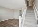 Inviting living room with hardwood floors and staircase leading to upper level at 4670 W Nevada Pl # A, Denver, CO 80219