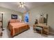 Cozy bedroom featuring a ceiling fan, soft carpet, and dresser with a decorative mirror at 20510 Oakbrook Ln, Parker, CO 80138