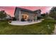 An aerial view of the backyard showing the patio, house, and landscaped yard at sunset at 20510 Oakbrook Ln, Parker, CO 80138