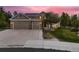 Charming two-story home with stone accents, a three-car garage, and a well-maintained lawn at 20510 Oakbrook Ln, Parker, CO 80138