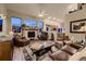 Inviting living room with fireplace, large windows offering ample light, and open to the kitchen at 20510 Oakbrook Ln, Parker, CO 80138